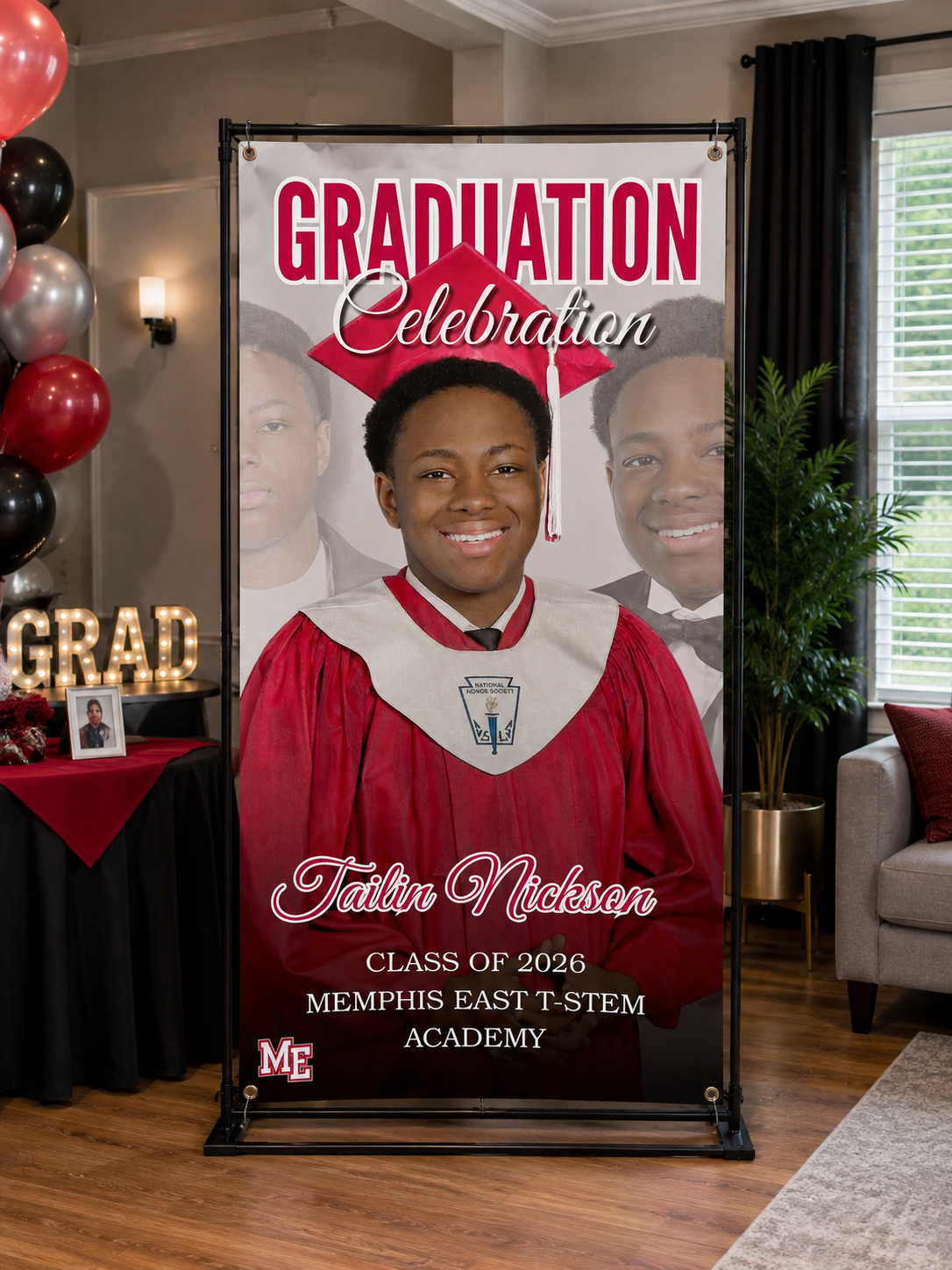 Custom red and white graduation banner on freestanding frame