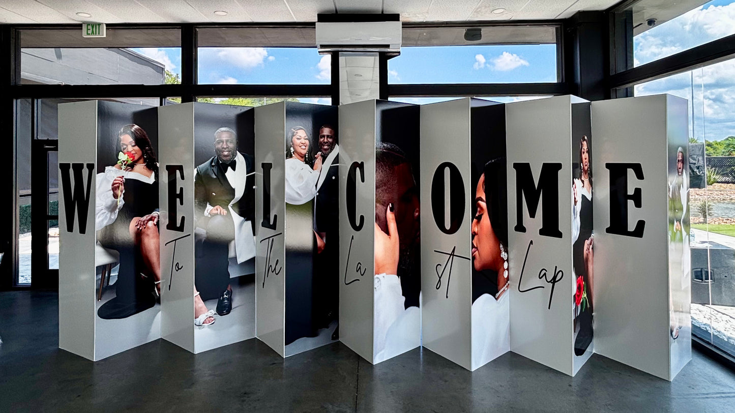Custom accordion board welcome sign with couple portraits printed on panels