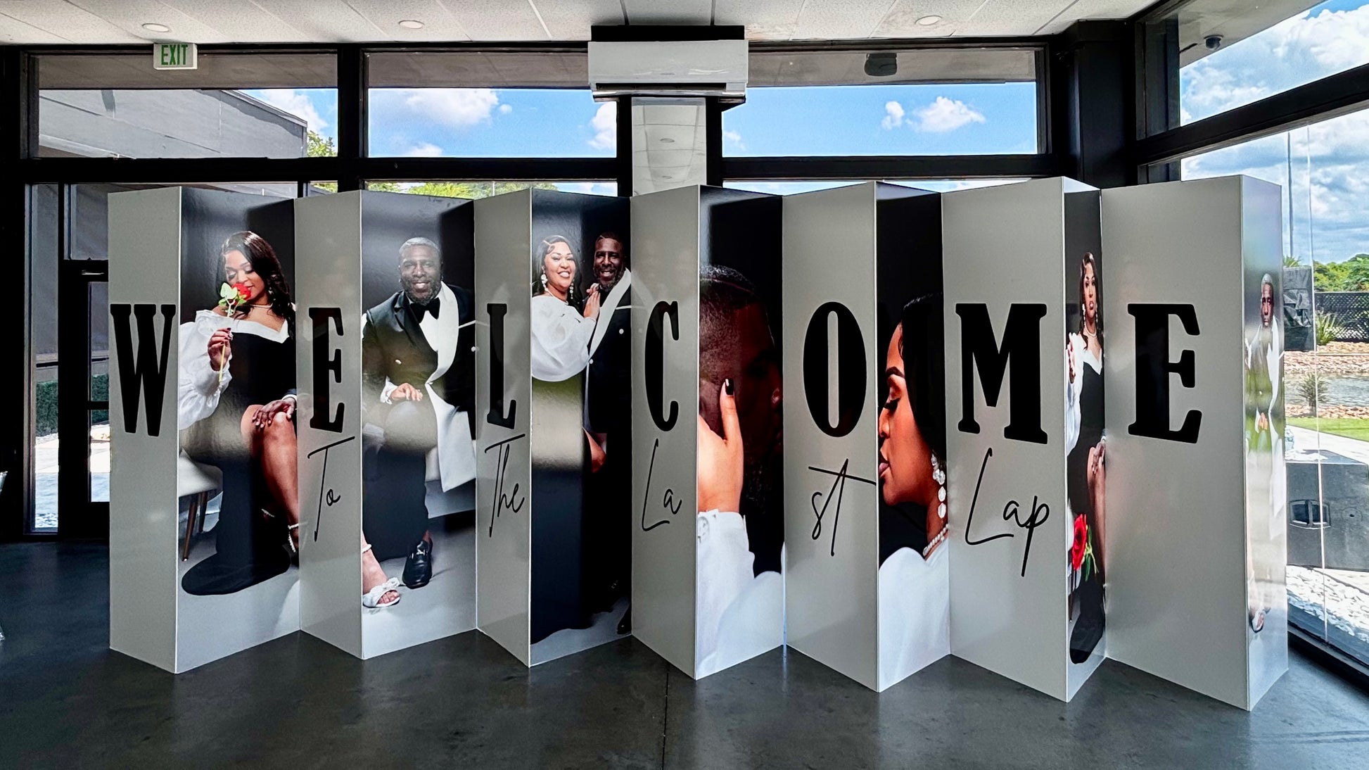 Custom accordion board welcome sign with couple portraits printed on panels