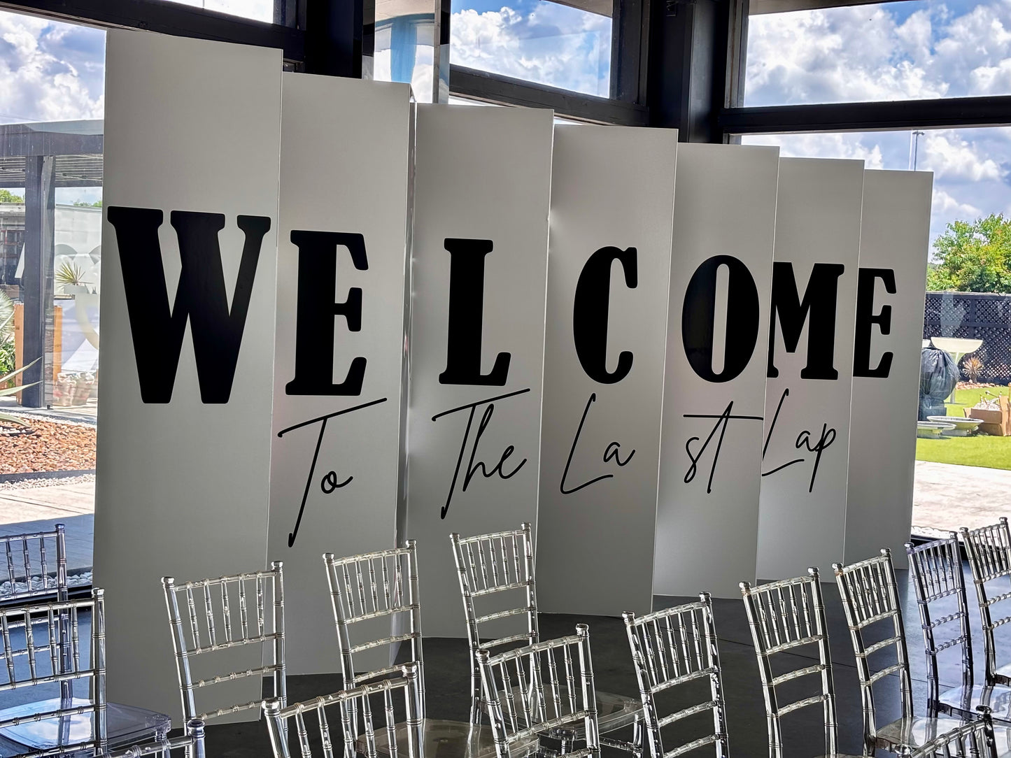 Custom "Welcome to the Last Lap" accordion board letters at event entrance