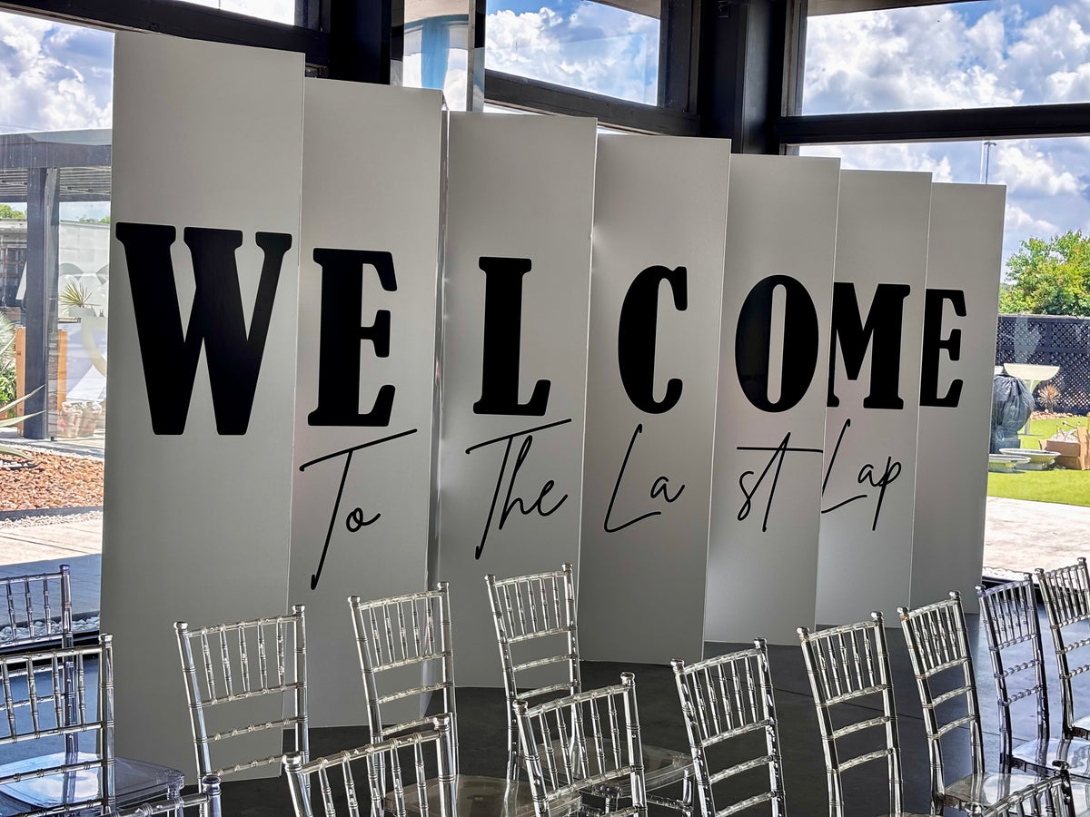 Custom "Welcome to the Last Lap" accordion board letters at event entrance